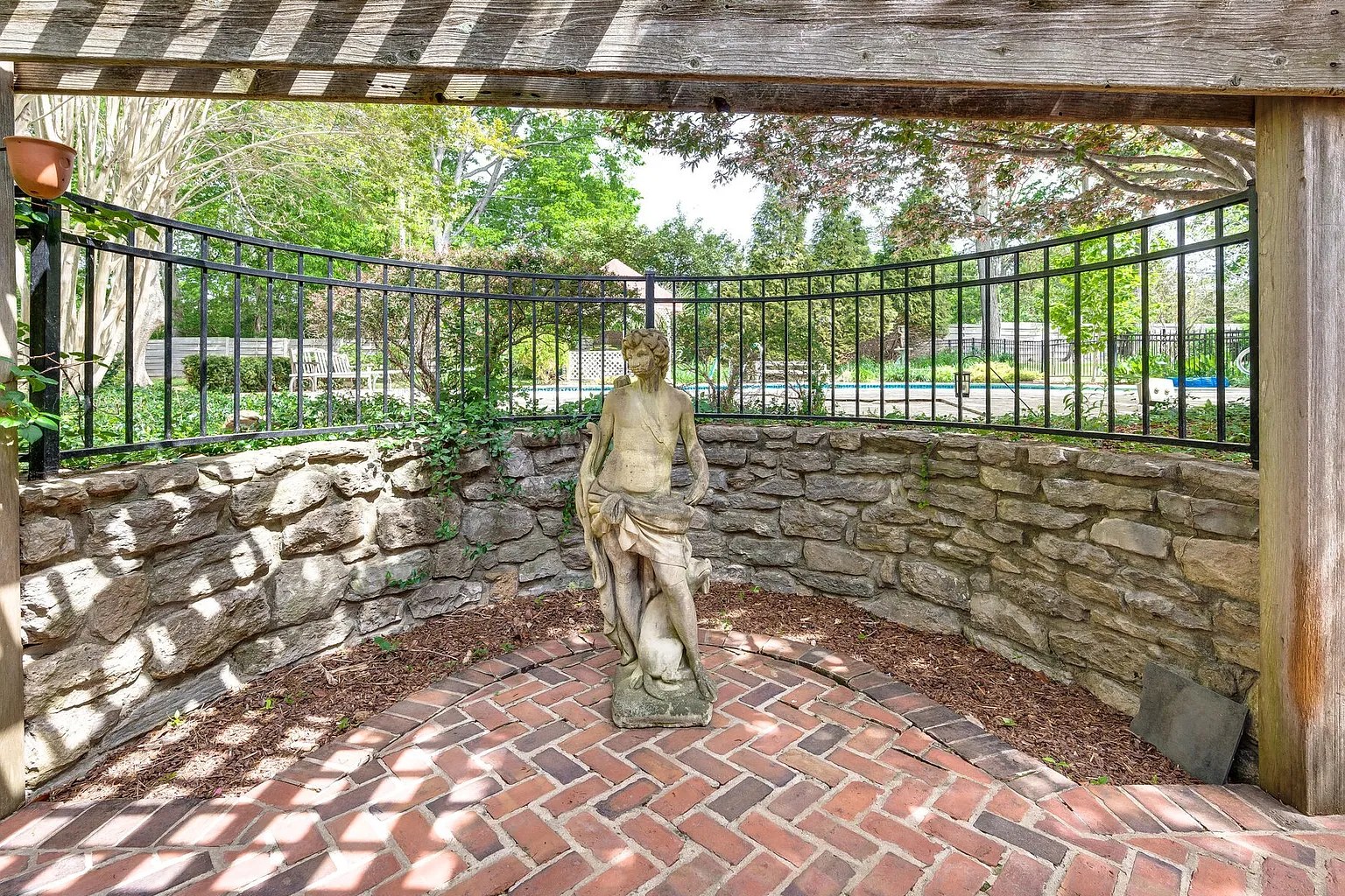 Stone garden terrace with pergola on a Brentwood property