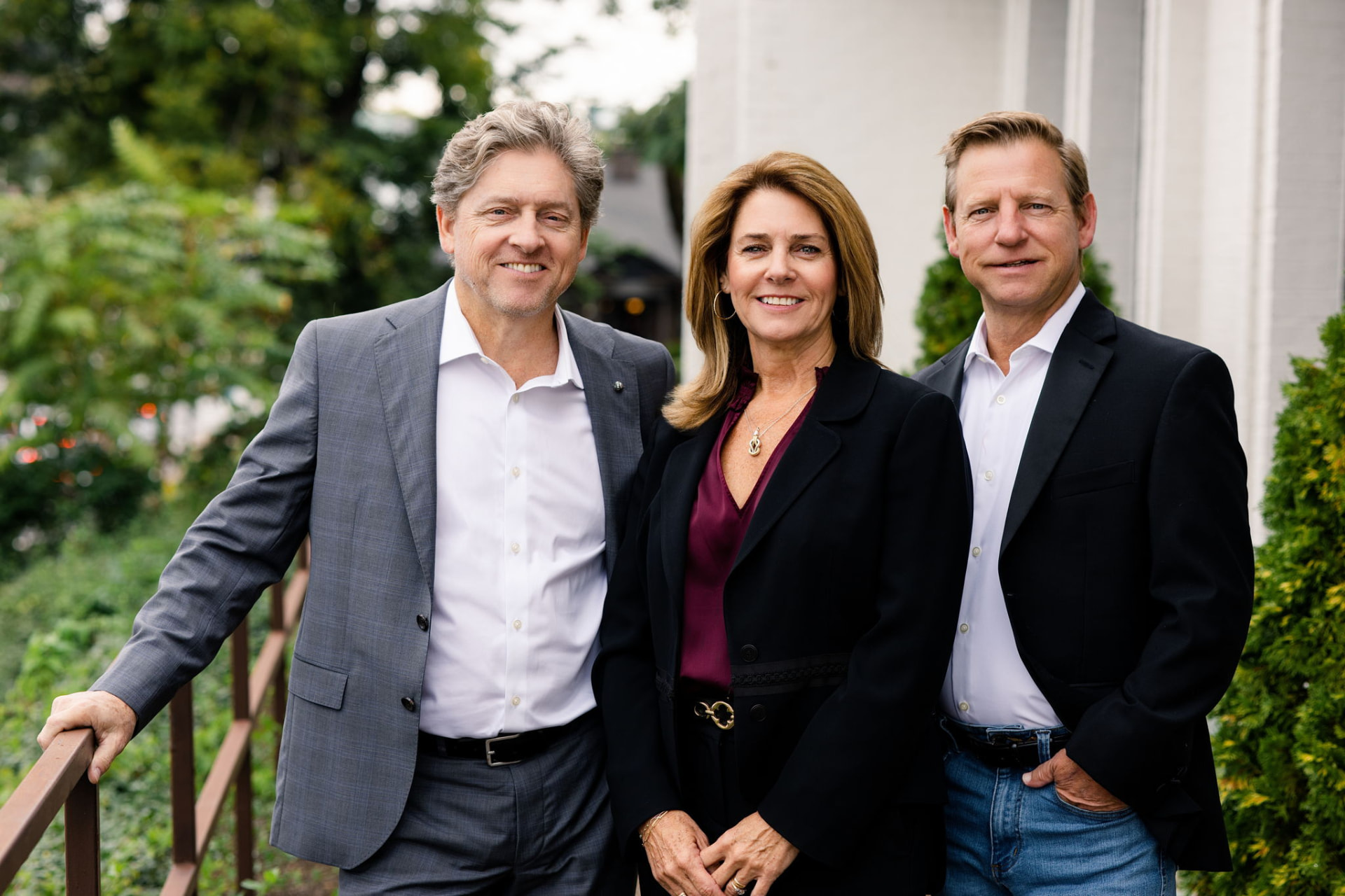 The Holmes and Pruett Homes Team standing together outdoors on a Nashville walkway